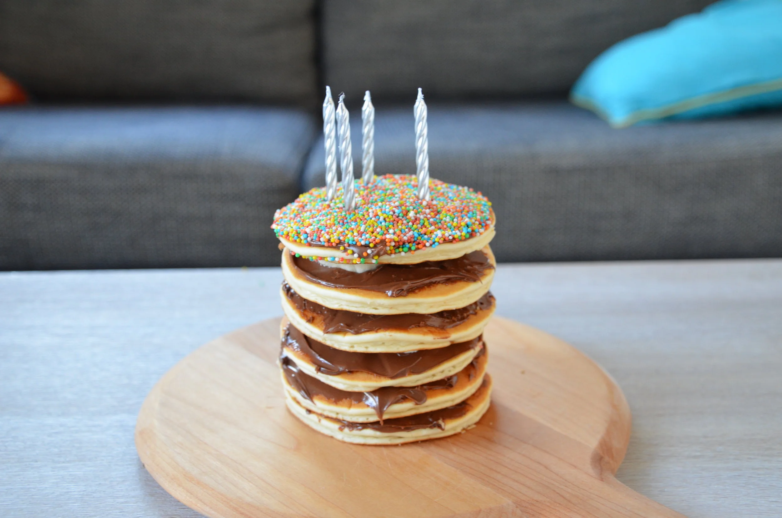 A pancake stack birthday cake with Nutella and banana