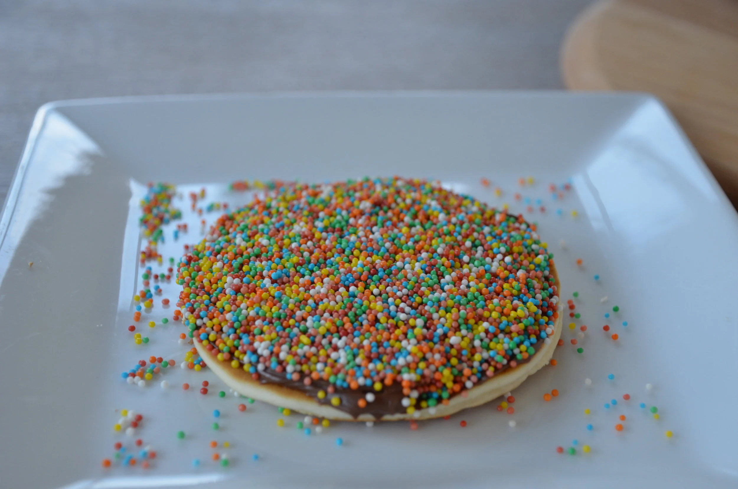 Assembling the layered pancake cake with Nutella and banana