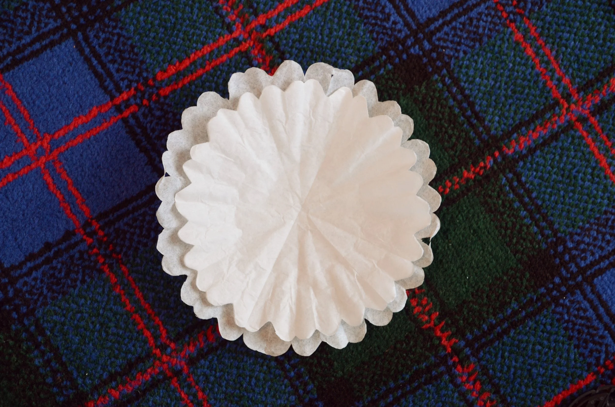 Layered coffee filter pieces pinched at the centre to form a flower