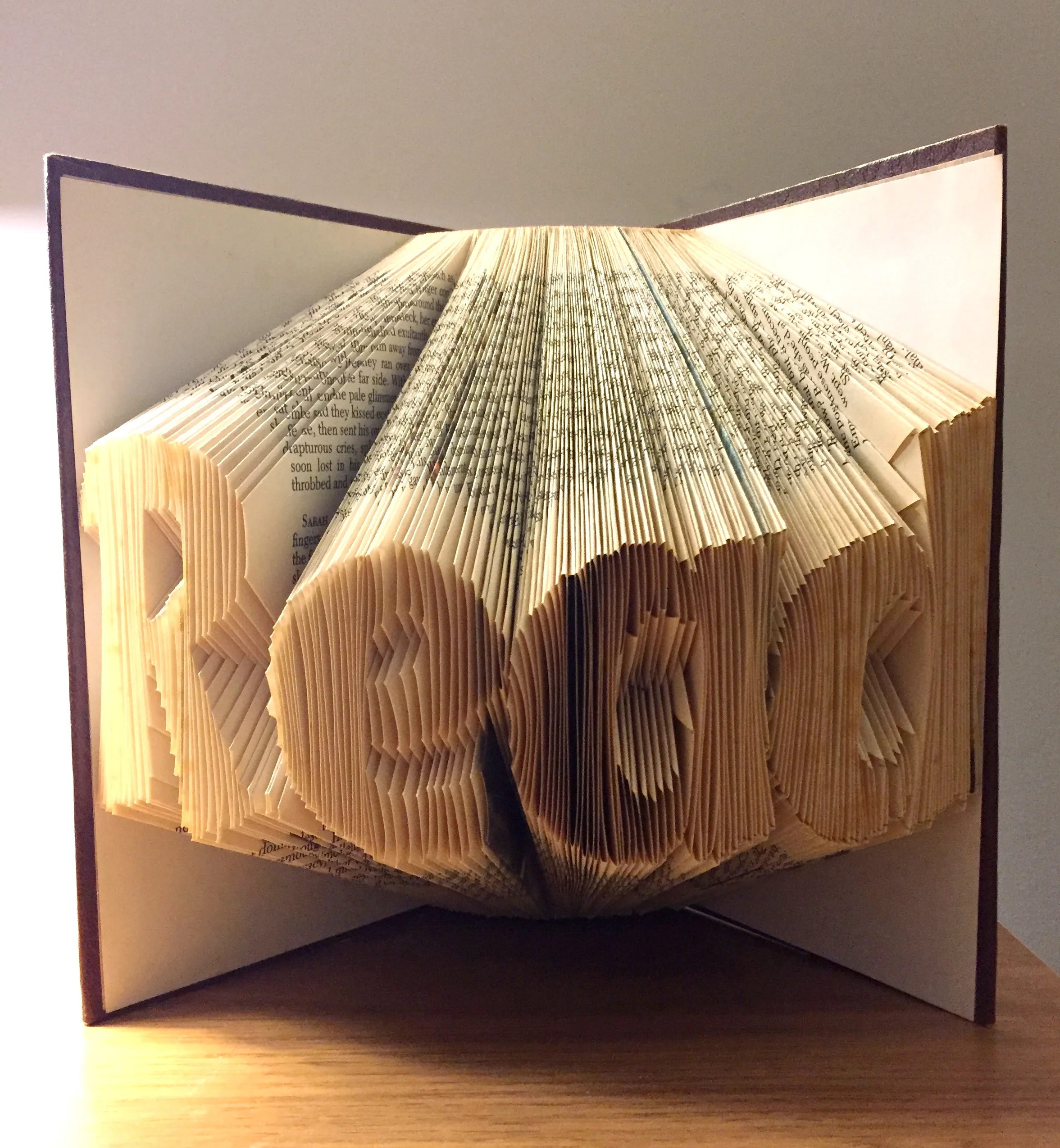 Completed folded book with all pages folded to form the word