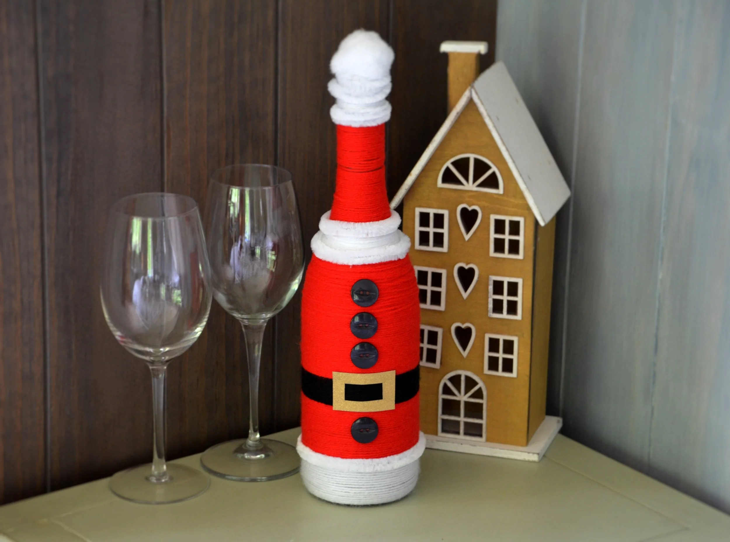 Belt buckle and button attached to the front of the Santa bottle