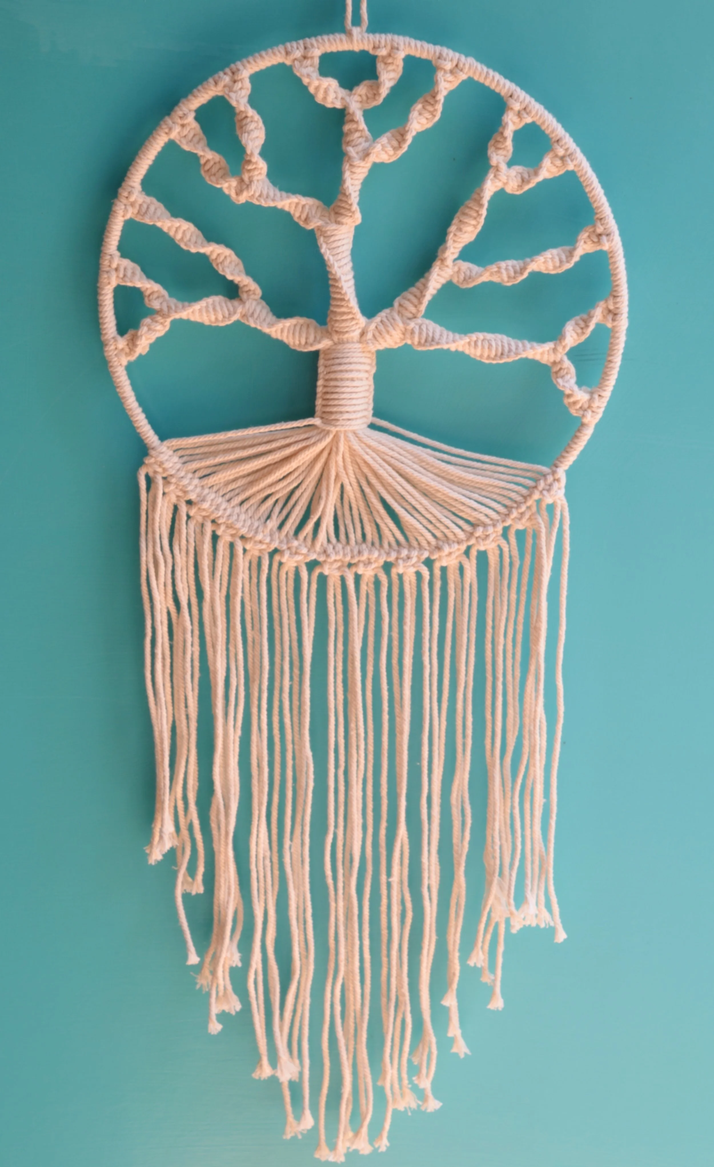 A macram&eacute; tree of life wall hanging