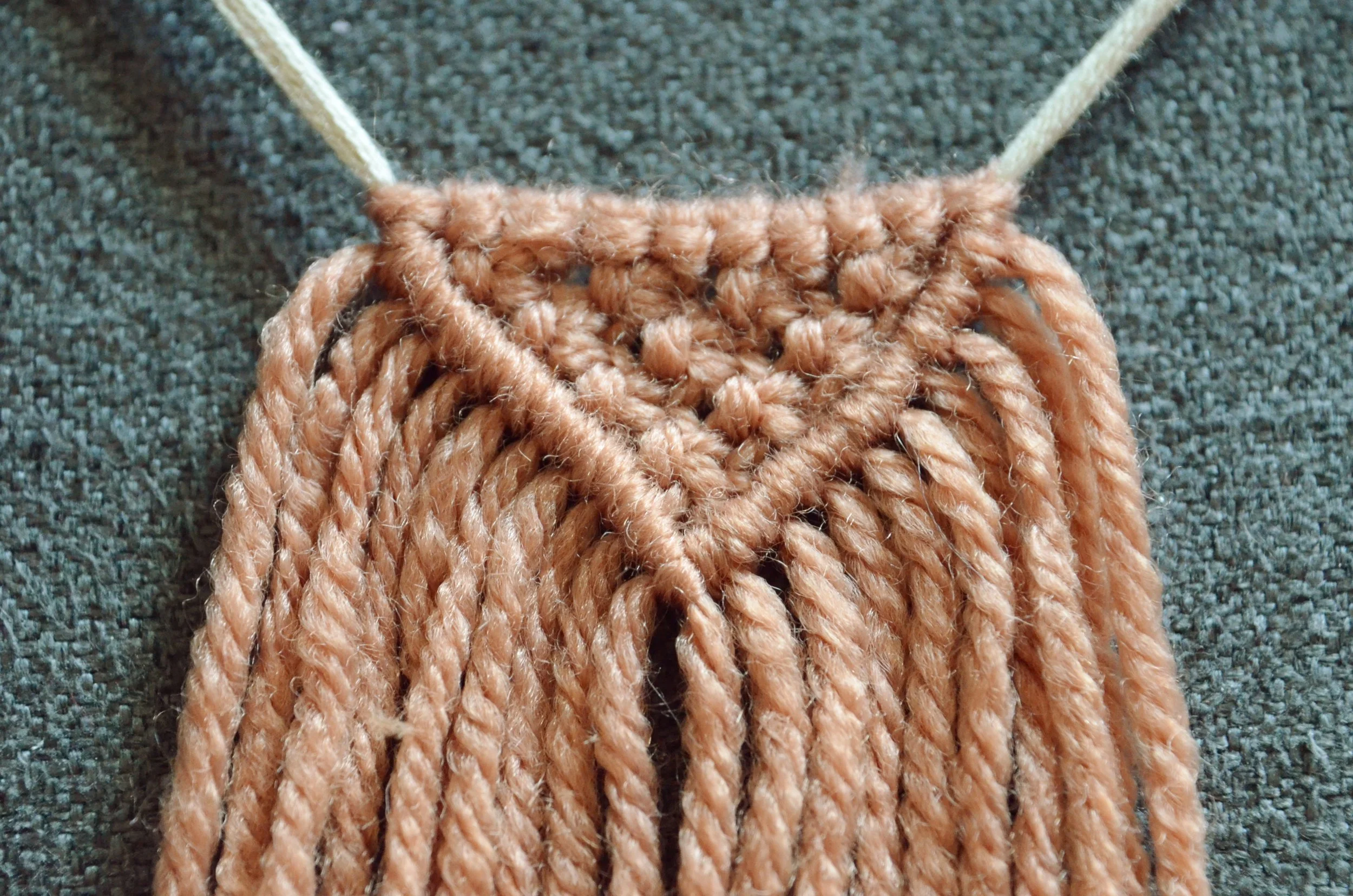 A macram&eacute; tree of life wall hanging